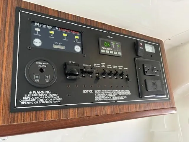 Slide: The Image of Control panel of a 2020 Pursuit S 328 Sport boat with various switches and warnings. - 29