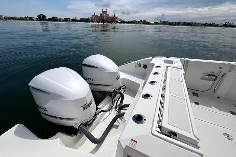 Slide: The Image of 2020 Pursuit S 328 Sport boat with dual Yamaha engines on calm water. - 3