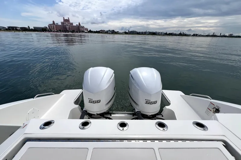 Slide: The Image of 2020 Pursuit S 328 Sport boat with twin Yamaha 300 engines on calm water. - 4