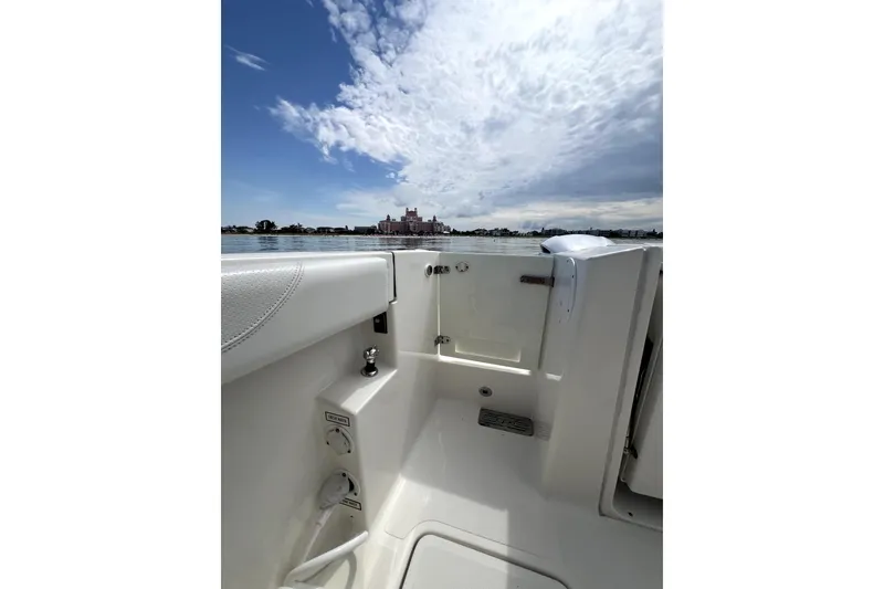 Slide: The Image of 2020 Pursuit S 328 Sport boat interior with ocean view and cloudy sky. - 6