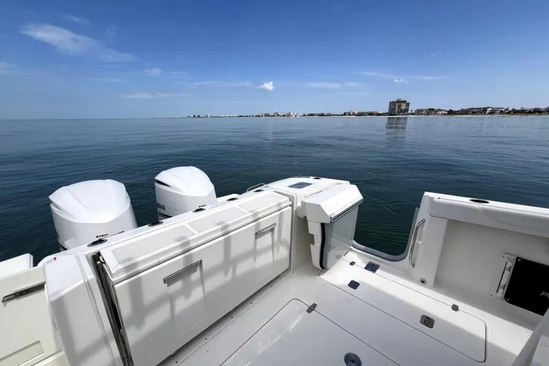 Slide: The Image of 2020 Pursuit S 328 Sport boat with dual engines on calm water. - 7