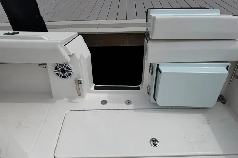 Slide: The Image of 2026 Regulator 37 boat interior with storage compartments and speaker. - 13