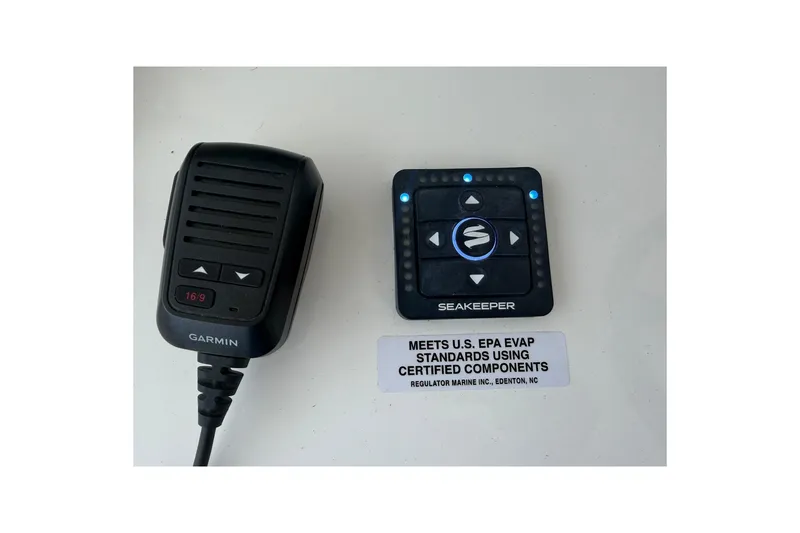 Slide: The Image of Garmin microphone and Seakeeper control panel on Regulator 37, 2026 model boat. - 19
