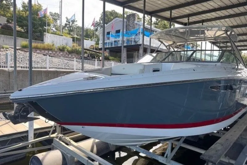 Slide: The Image of 2017 Cobalt R35 boat docked under a covered marina, showcasing sleek design. - 7