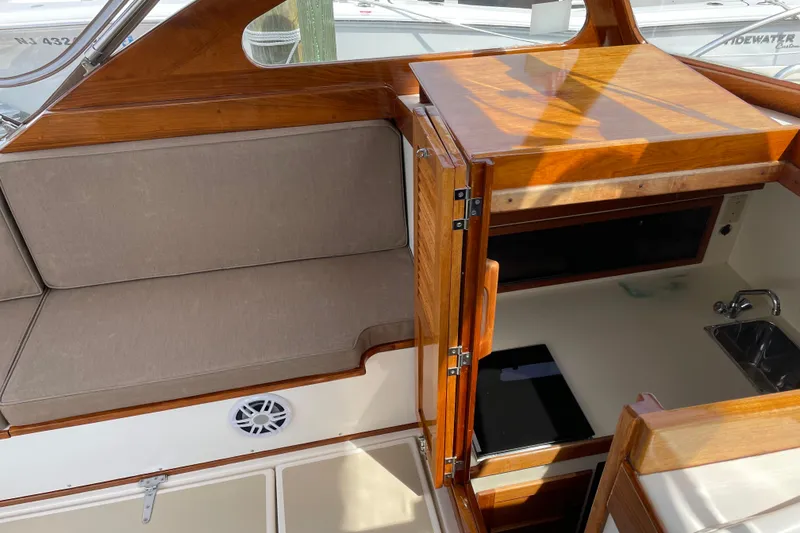 Slide: The Image of 2003 Dyer 29 Soft Top interior with wooden cabinetry and cushioned seating. - 10