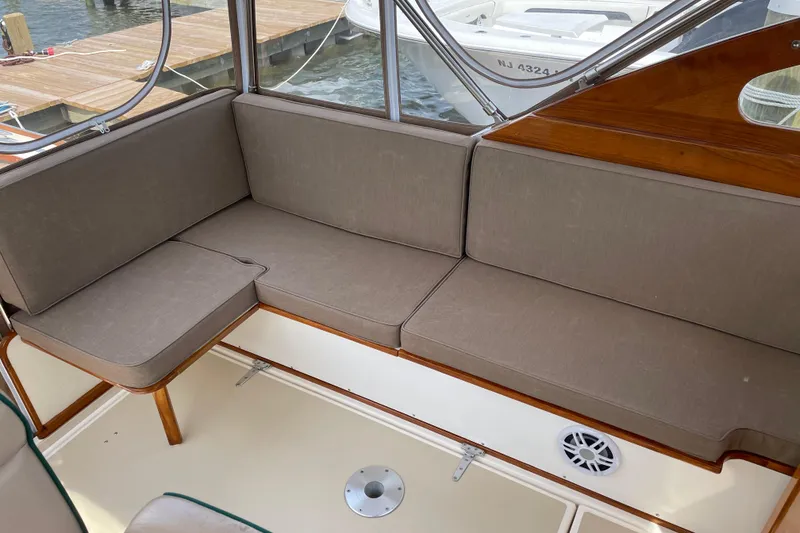 Slide: The Image of Interior seating of 2003 Dyer 29 Soft Top boat with beige cushions. - 11