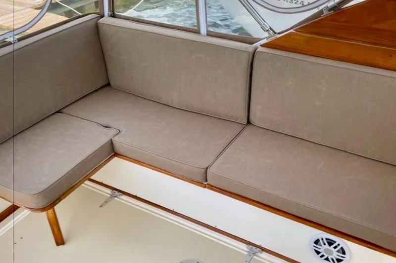Slide: The Image of Beige cushioned seating on 2003 Dyer 29 Soft Top boat interior. - 12