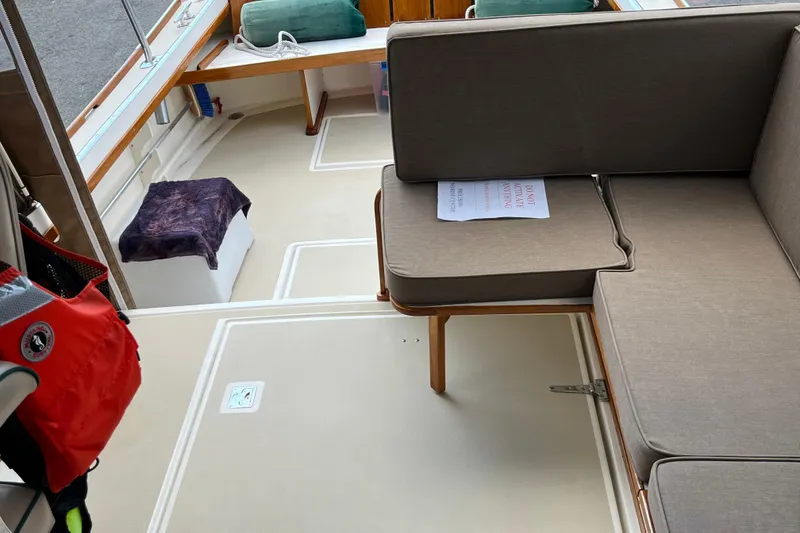 Slide: The Image of Interior of a 2003 Dyer 29 Soft Top boat with seating and life jacket. - 13