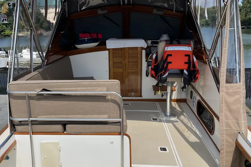 Slide: The Image of 2003 Dyer 29 Soft Top boat interior with seating and life jacket. - 14