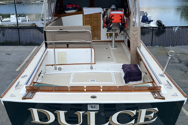 Slide: The Image of 2003 Dyer 29 Soft Top boat docked, featuring spacious deck and safety equipment. - 17