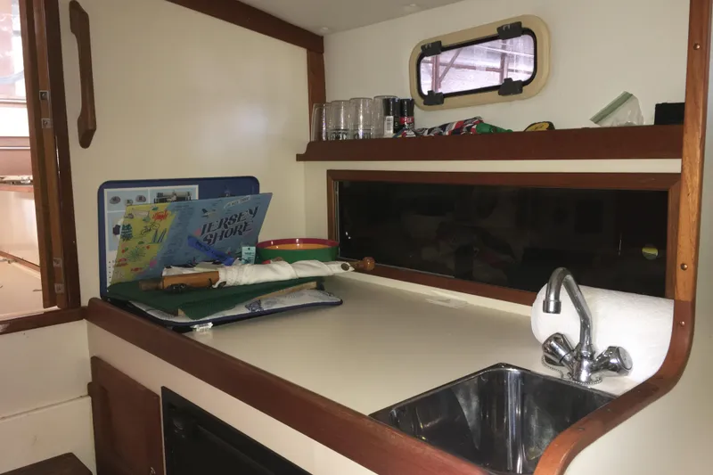 Slide: The Image of 2003 Dyer 29 Soft Top boat interior with sink and countertop accessories. - 21