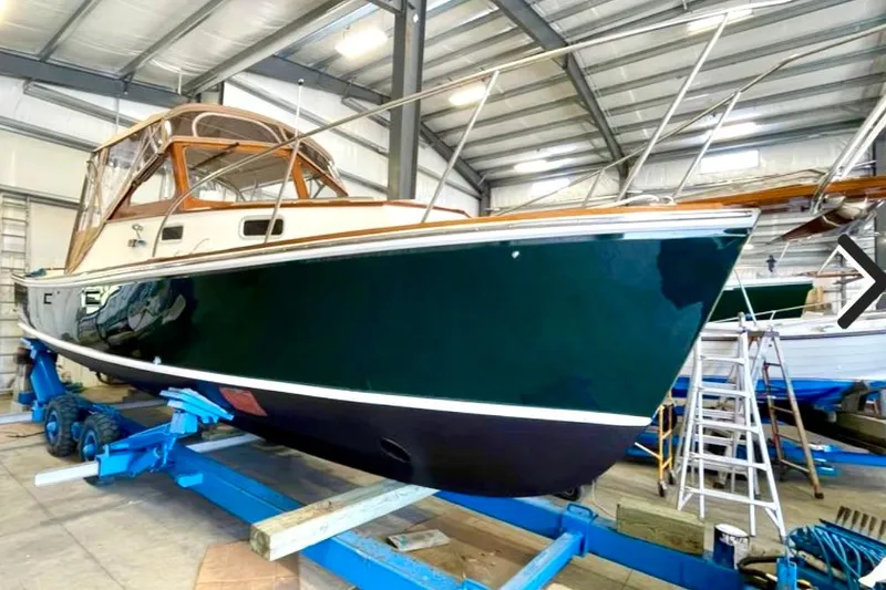 Slide: The Image of 2003 Dyer 29 Soft Top boat in a storage facility on a blue trailer. - 27