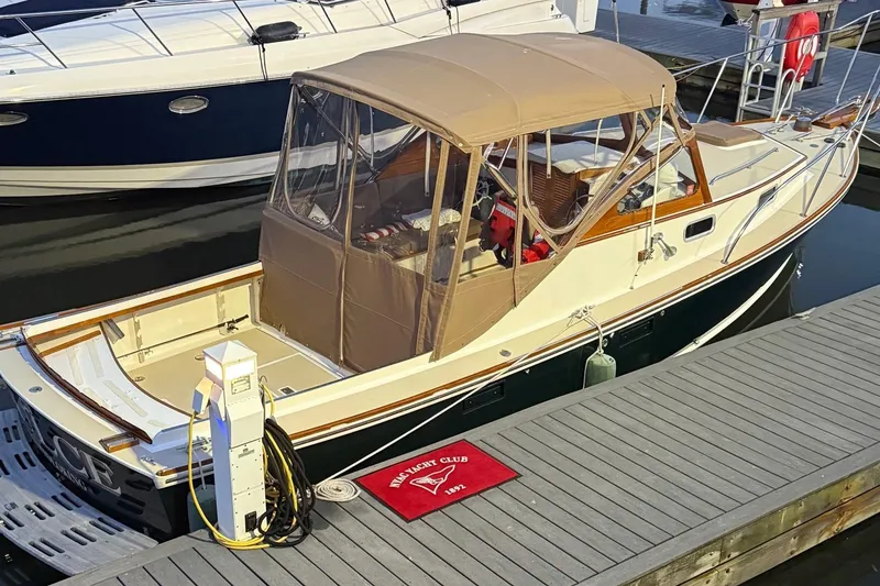 Slide: The Image of 2003 Dyer 29 Soft Top boat docked at marina with tan canopy. - 3