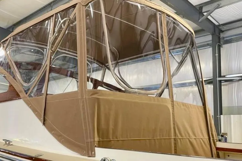 Slide: The Image of 2003 Dyer 29 Soft Top boat with tan canvas enclosure in a warehouse. - 30
