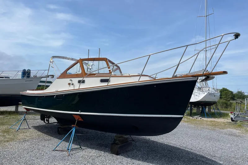 Slide: The Image of 2003 Dyer 29 Soft Top boat on stands, displayed outdoors under a clear sky. - 31