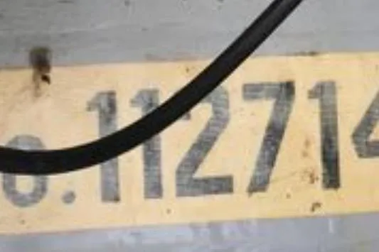 Slide: The Image of Close-up of Dyer 29 Soft Top 2003 boat serial number on a yellow background. - 34