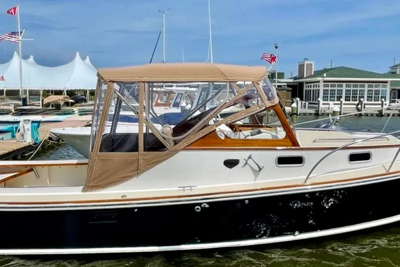 Slide: The Image of 2003 Dyer 29 Soft Top boat docked at marina with tan canopy. - 35