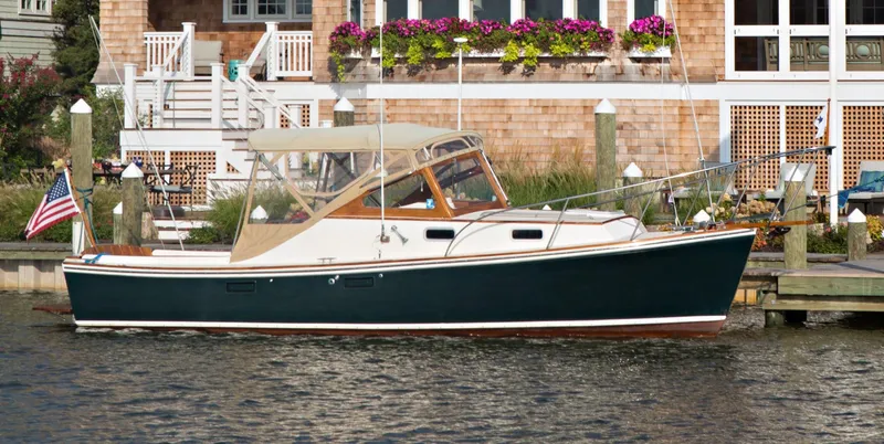 Slide: The Image of 2003 Dyer 29 Soft Top boat docked by a charming waterfront home. - 36