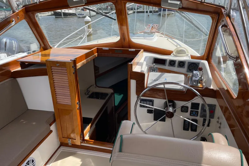 Slide: The Image of 2003 Dyer 29 Soft Top boat interior with steering wheel and navigation equipment. - 4
