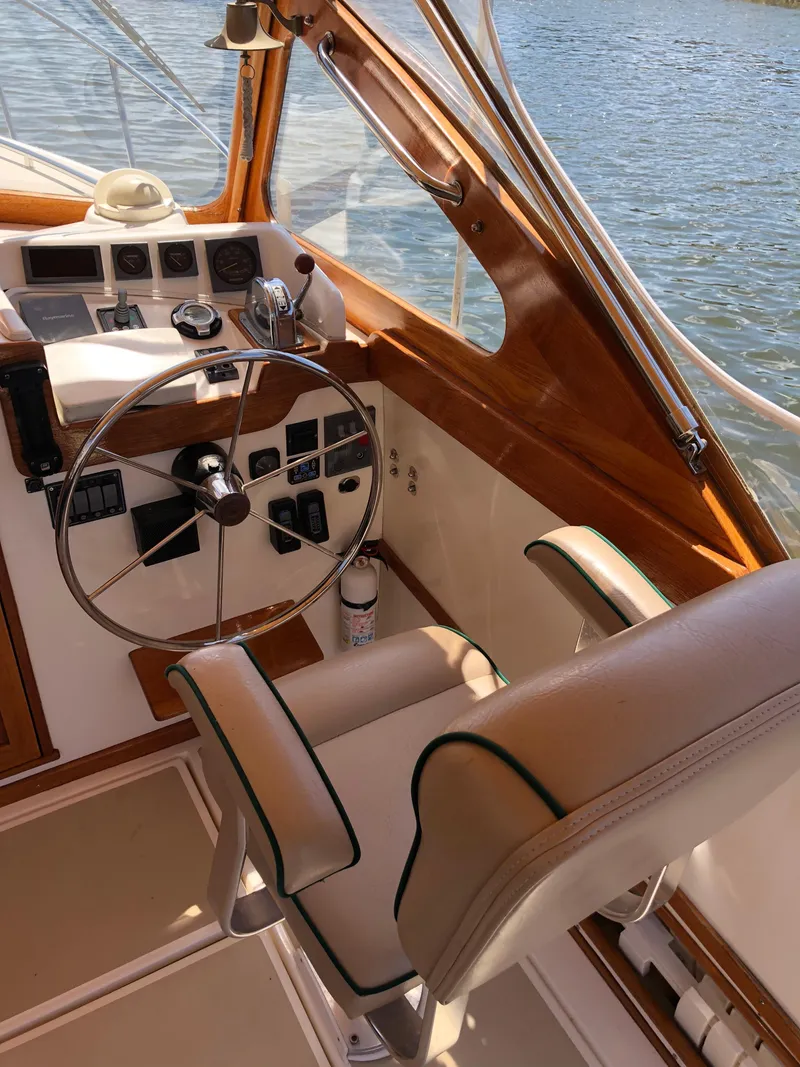 Slide: The Image of 2003 Dyer 29 Soft Top boat interior with steering wheel and control panel. - 6