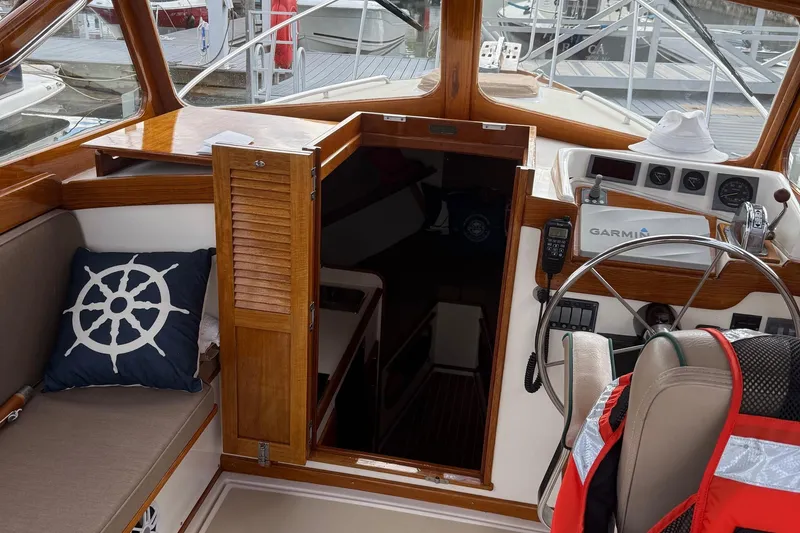 Slide: The Image of 2003 Dyer 29 Soft Top boat interior with helm, navigation equipment, and nautical decor. - 7