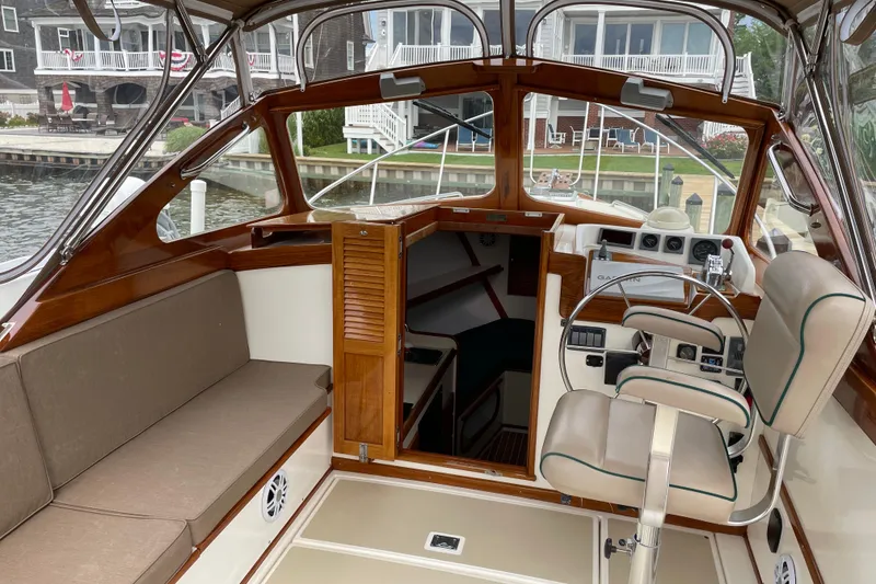 Slide: The Image of 2003 Dyer 29 Soft Top boat interior with helm, seating, and cabin entrance. - 8