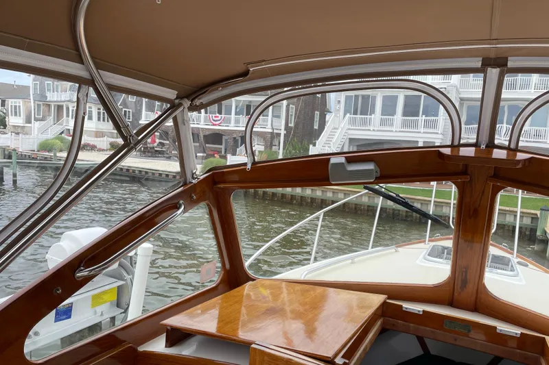 Slide: The Image of Interior view of 2003 Dyer 29 Soft Top boat with waterfront homes in background. - 9