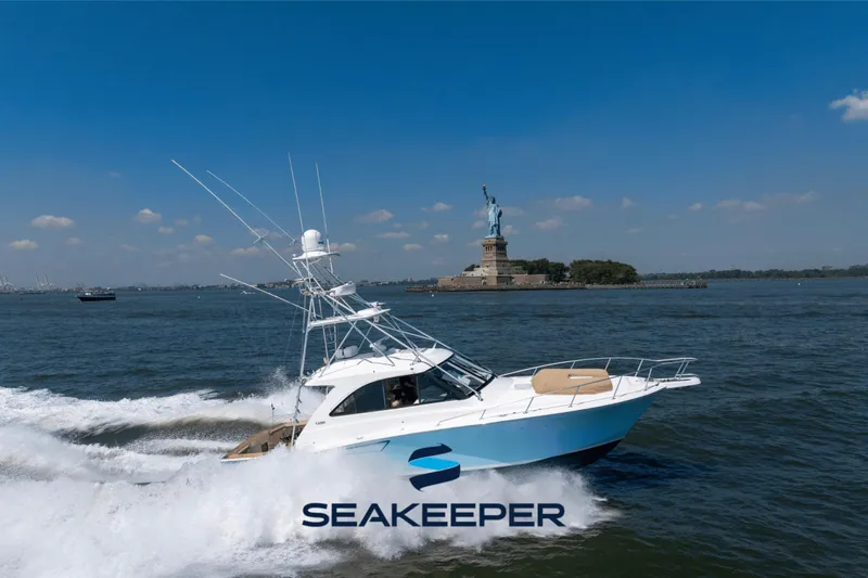 The Image of Cabo 44 Hardtop Express 2012 cruising near Statue of Liberty on a sunny day. - 0