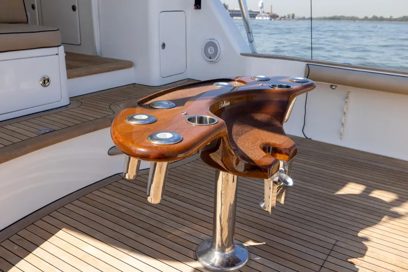 Slide: The Image of Wooden detail on 2012 Cabo 44 Hardtop Express boat, featuring "Release" text. - 100