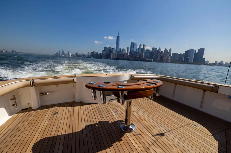 Slide: The Image of Cabo 44 Hardtop Express 2012 cruising with city skyline in background. - 102