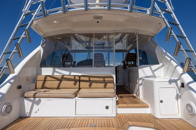 Slide: The Image of 2012 Cabo 44 Hardtop Express yacht interior with teak deck and cushioned seating. - 107