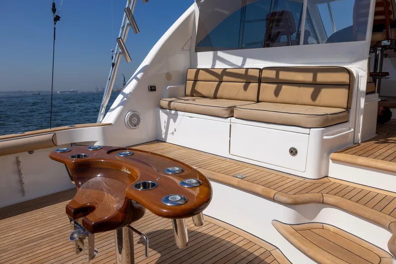 Slide: The Image of 2012 Cabo 44 Hardtop Express yacht with spacious deck and seating, cruising on open water. - 110