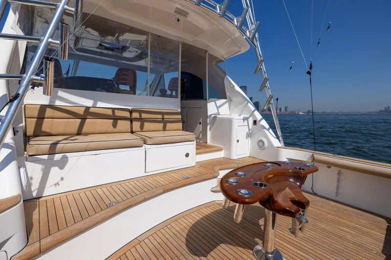 Slide: The Image of Luxurious 2012 Cabo 44 Hardtop Express yacht deck with seating and fishing station. - 111