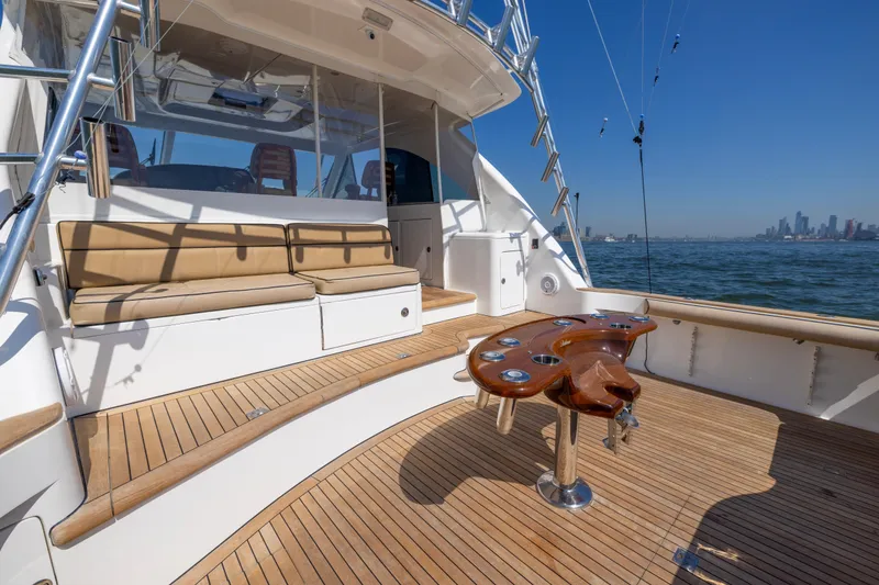 Slide: The Image of 2012 Cabo 44 Hardtop Express yacht with teak deck and cushioned seating. - 112