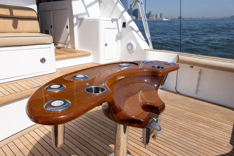 Slide: The Image of Luxurious 2012 Cabo 44 Hardtop Express yacht deck with elegant wood finishes. - 115