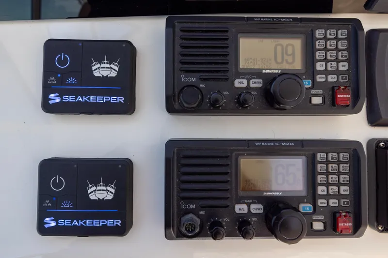 Slide: The Image of Helm of 2012 Cabo 44 Hardtop Express with navigation screens and steering wheel. - 120