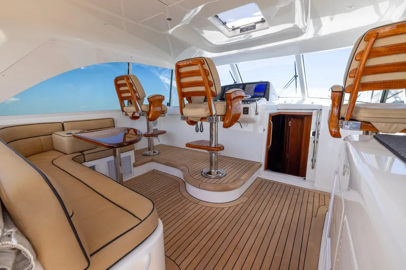 Slide: The Image of Luxurious interior of 2012 Cabo 44 Hardtop Express yacht with elegant seating and navigation area. - 123