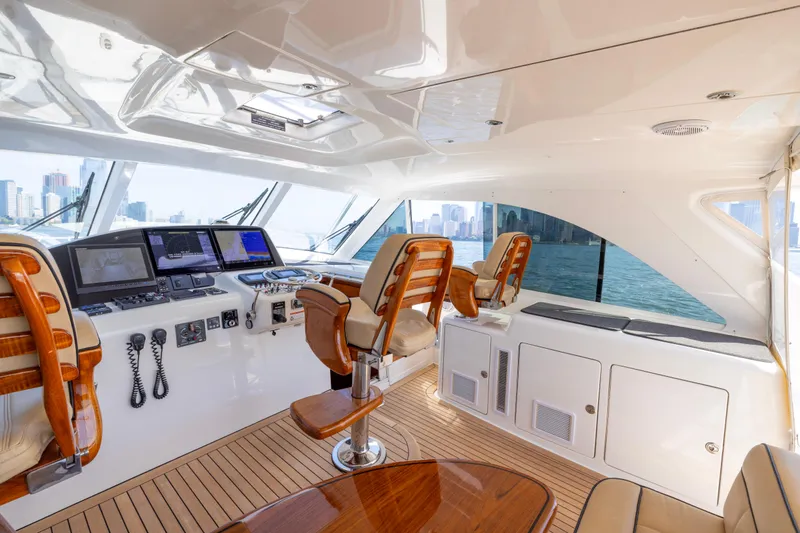 Slide: The Image of Luxurious interior of 2012 Cabo 44 Hardtop Express yacht with elegant seating and helm chairs. - 124
