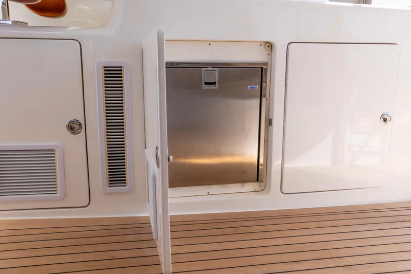 Slide: The Image of Luxurious 2012 Cabo 44 Hardtop Express yacht interior with helm station and city skyline view. - 126