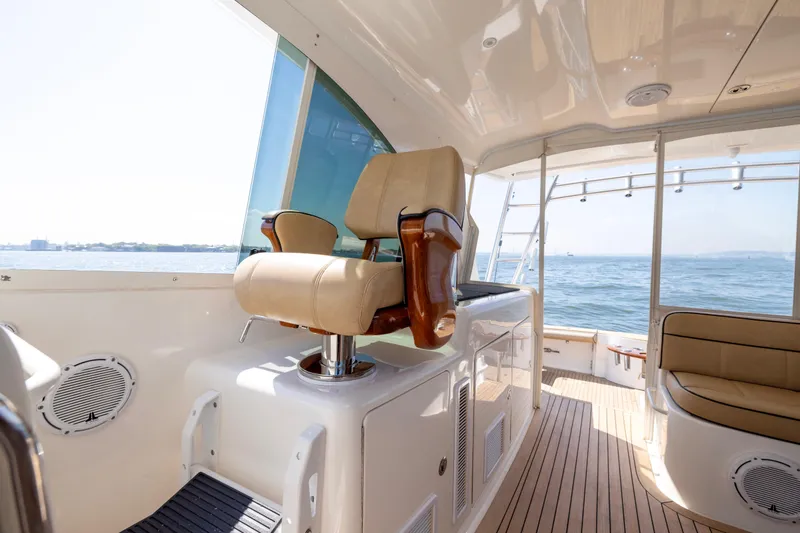 Slide: The Image of 2012 Cabo 44 Hardtop Express yacht with open storage compartment and stainless steel appliance. - 128