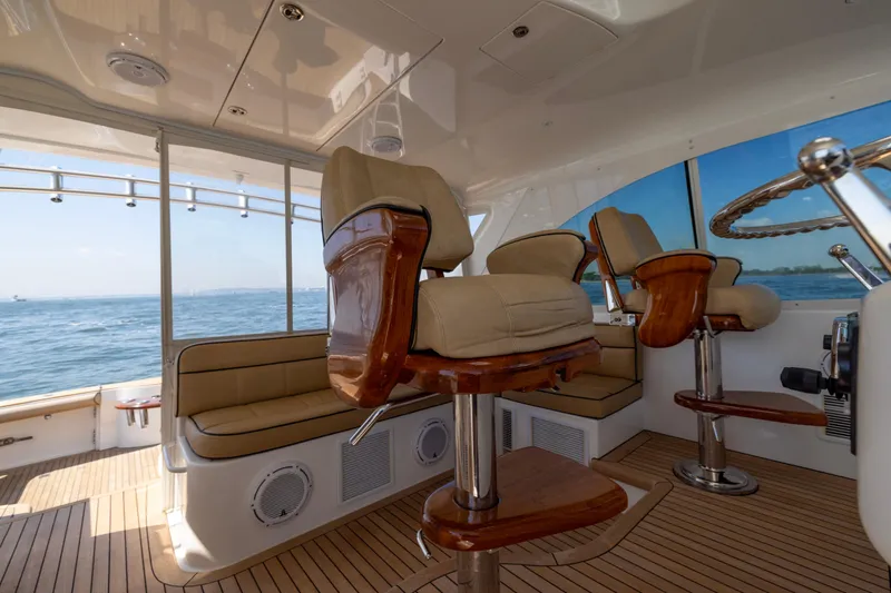 Slide: The Image of Luxurious 2012 Cabo 44 Hardtop Express yacht interior with ocean view and plush seating. - 129