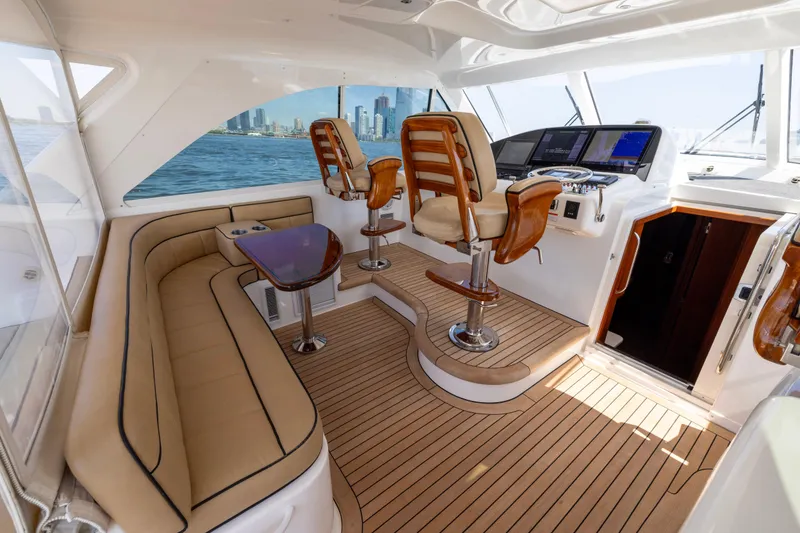 Slide: The Image of Luxurious interior of 2012 Cabo 44 Hardtop Express yacht with elegant seating and ocean view. - 132