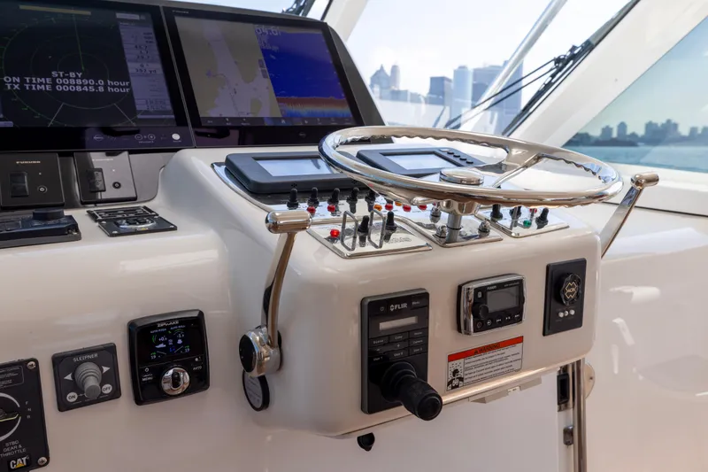 Slide: The Image of Control panel of a 2012 Cabo 44 Hardtop Express yacht with navigation equipment. - 139