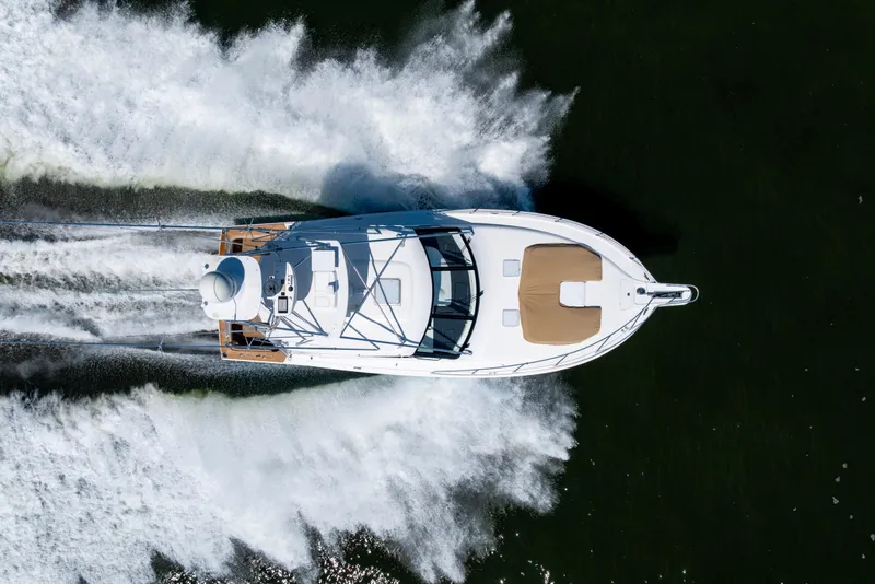 Slide: The Image of Overhead view of 2012 Cabo 44 Hardtop Express yacht cruising on water. - 24