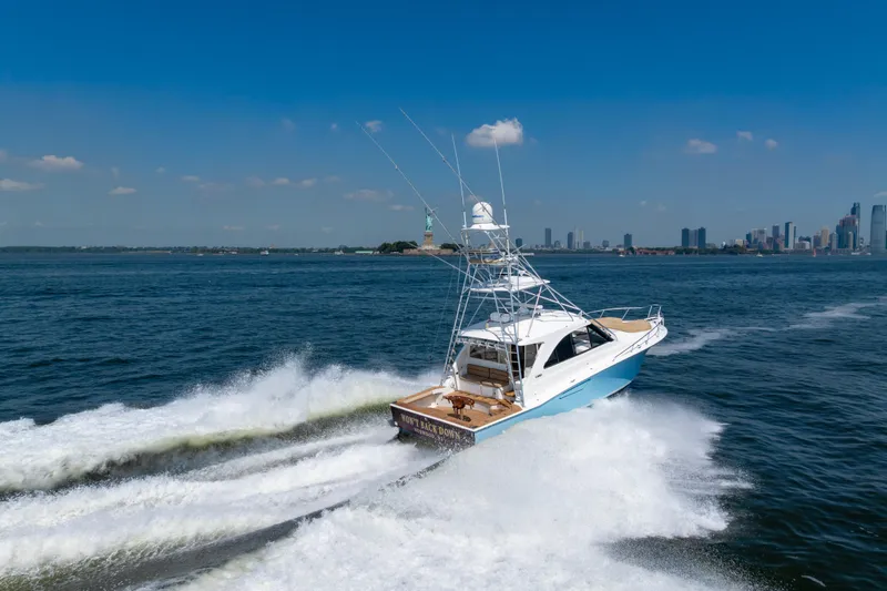 Slide: The Image of 2012 Cabo 44 Hardtop Express yacht cruising near city skyline and Statue of Liberty. - 26