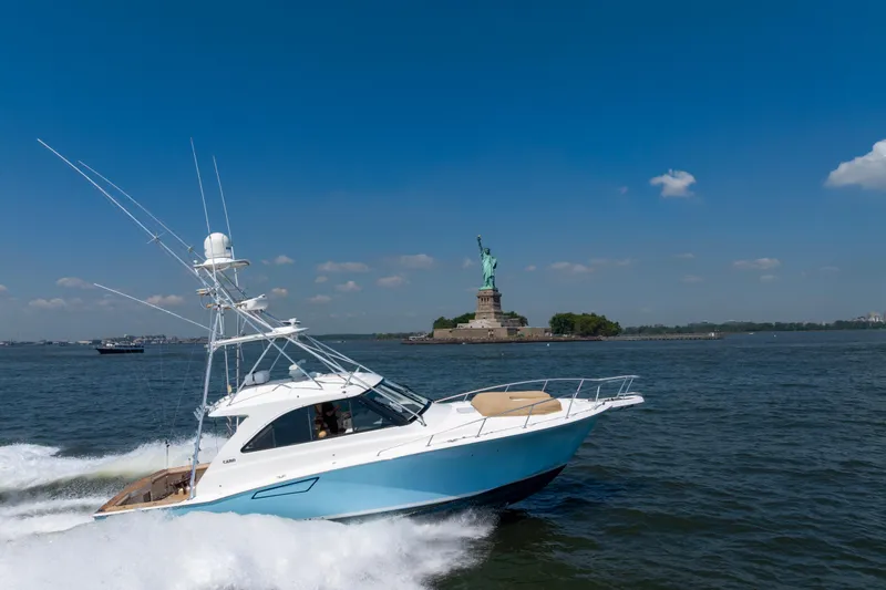 Slide: The Image of 2012 Cabo 44 Hardtop Express yacht cruising near the Statue of Liberty. - 3