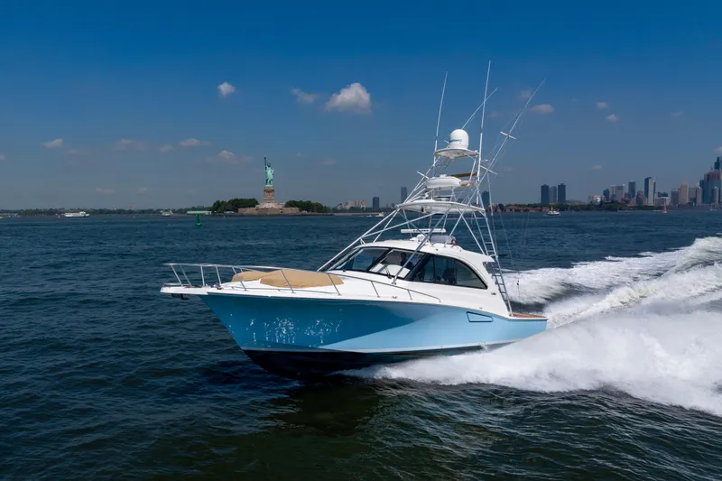 Slide: The Image of 2012 Cabo 44 Hardtop Express yacht cruising near the Statue of Liberty. - 30