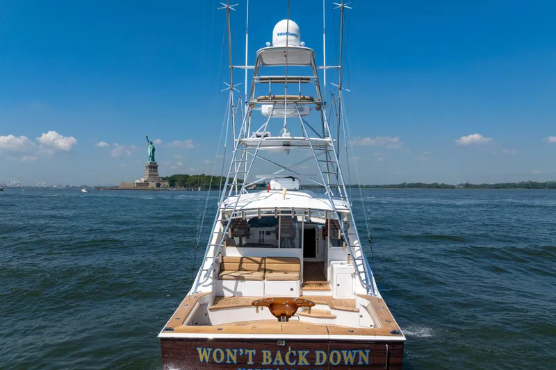 Slide: The Image of Cabo 44 Hardtop Express 2012 yacht near Statue of Liberty on a sunny day. - 36