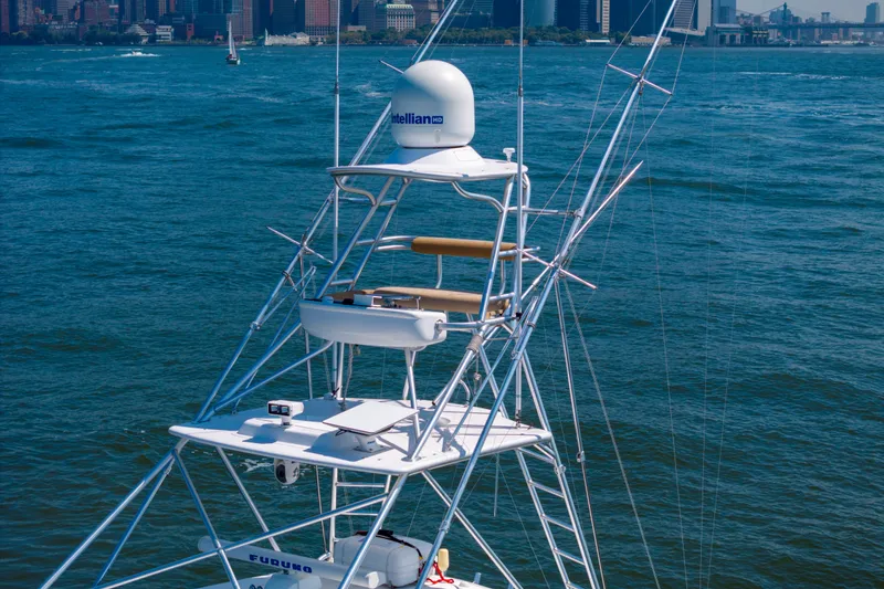 Slide: The Image of 2012 Cabo 44 Hardtop Express yacht tower with city skyline in background. - 40