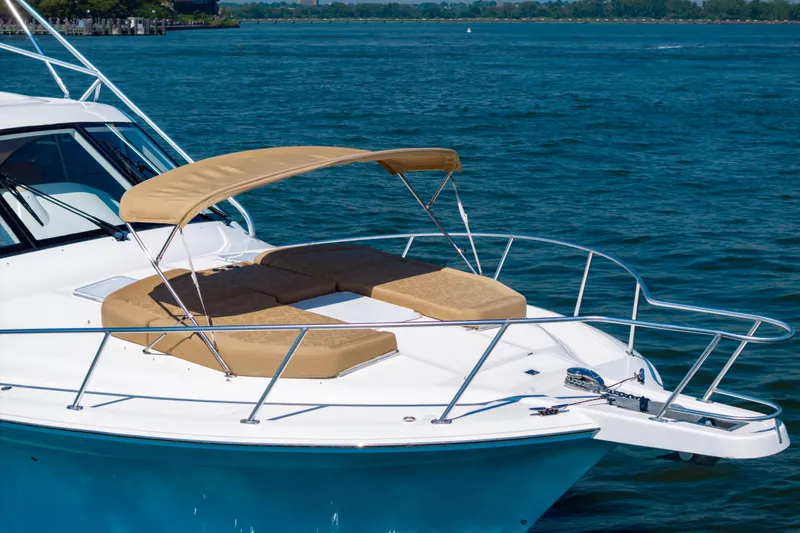 Slide: The Image of 2012 Cabo 44 Hardtop Express yacht with sunshade on open water. - 47